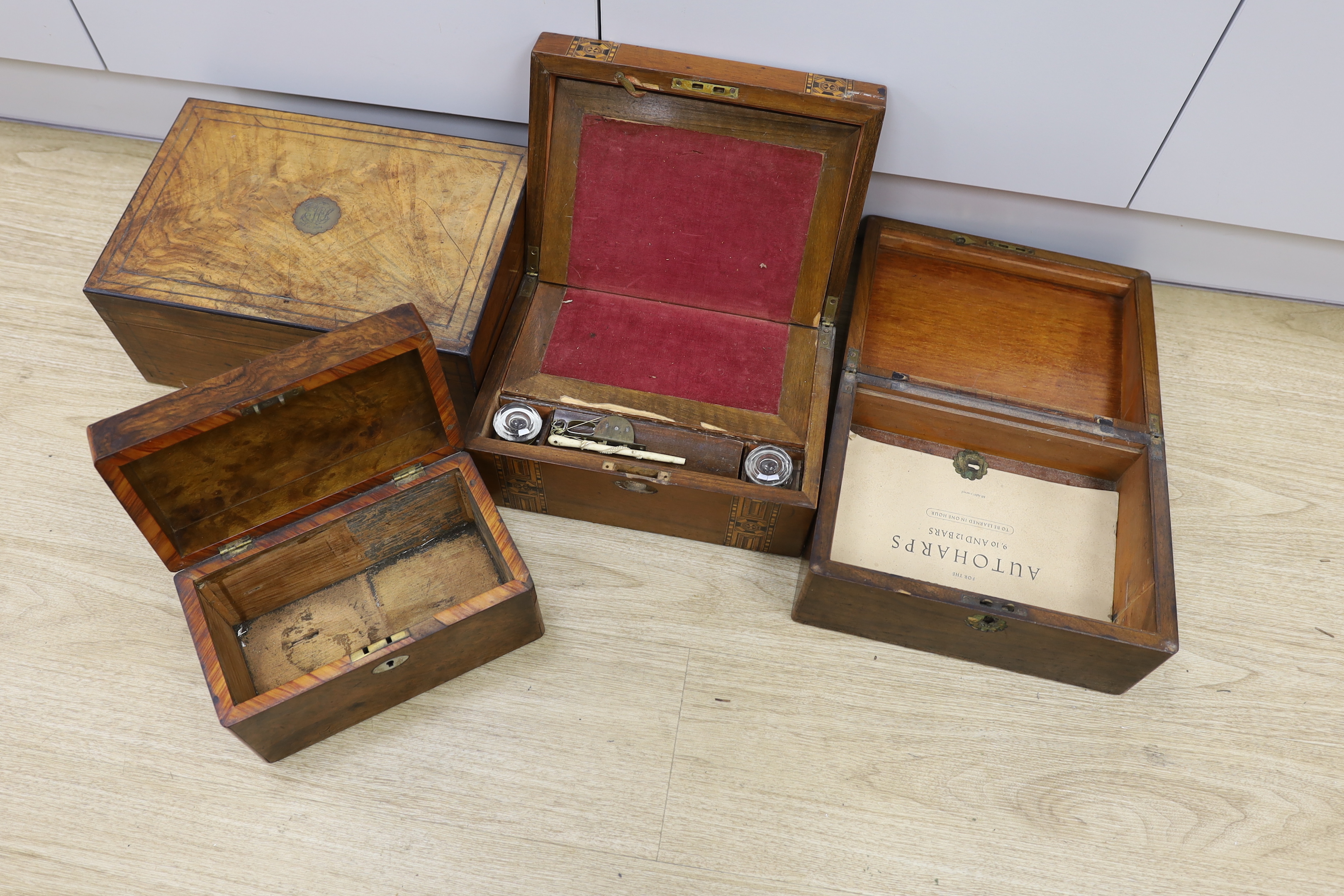 Three Victorian writing boxes and a tea caddy, largest 35cm wide, 15cm high, 24cm deep